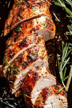 sliced pork with herbs and rosemary on the side