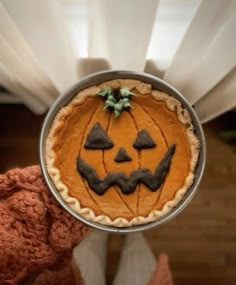 a pumpkin pie on top of a metal pan