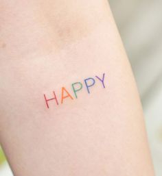 the word happy written in multicolored ink on someone's arm and leg