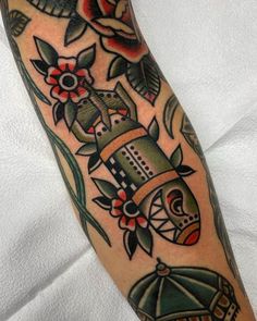 a person with a tattoo on their arm holding an umbrella and some other things in the background