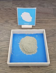 there is a blue tray with sand in it