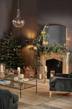 a living room filled with furniture and a fire place next to a christmas tree on top of a wooden floor