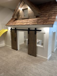 the inside of a house with two doors and a slide