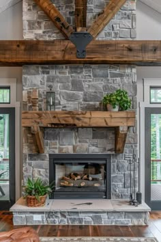 a stone fireplace in a living room with wood beams on the ceiling and an open fire place