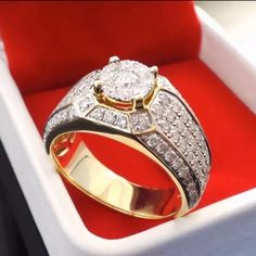 a diamond ring in a box with red velvet lining the bottom and gold trimmings