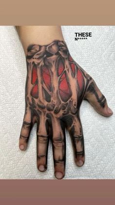 a hand with some tattoos on it