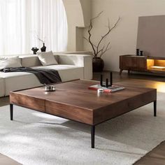 a living room with white couches and a coffee table