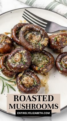 roasted mushrooms on a plate with rosemary garnish and a fork next to it