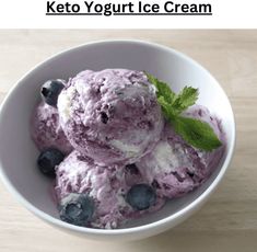 a white bowl filled with blueberries and ice cream