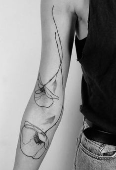 a woman's arm with an abstract tattoo design on the left side of her arm