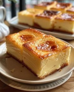 two slices of cheesecake sitting on top of a white plate next to each other