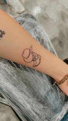 a woman's arm with a tattoo on it that has an elephant and moon