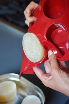 a person is pouring something into a bowl with two cups on the side and another cup in front of them