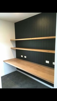 an empty room with some shelves on the wall and no one in it at all