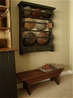 a wooden table sitting in front of a wall mounted shelf