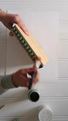 a person using a brush to paint a wall