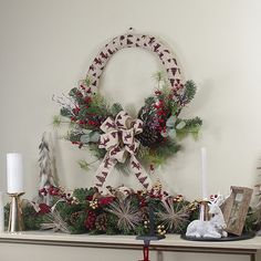 a mantle decorated with christmas decorations and candles