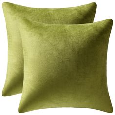 two lime green pillows sitting next to each other