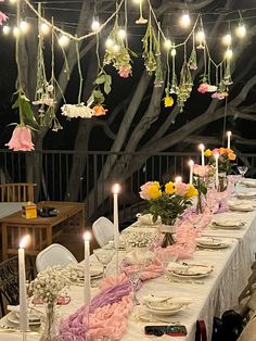 a long table with flowers and candles is set up for a formal dinner or party