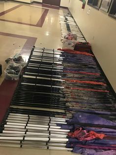 there are many clothes on the floor in this room, all lined up and ready to be sold