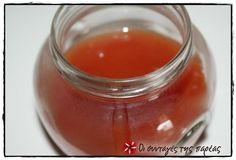 a glass jar filled with liquid sitting on top of a table