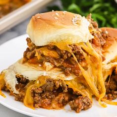 a close up of a plate of food with meat and cheese on it, next to some parsley