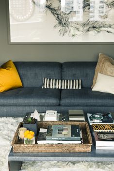 a living room with a blue couch and coffee table