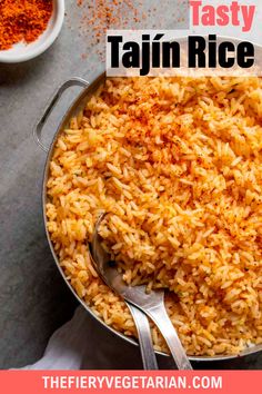 a pan filled with rice next to some spices