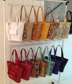 the purses are lined up on the rack