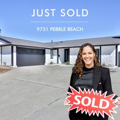 a woman holding a sold sign in front of a house with the words just sold