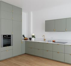 a kitchen with wooden floors and gray cabinets