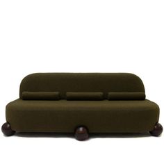 a green couch sitting on top of a wooden table