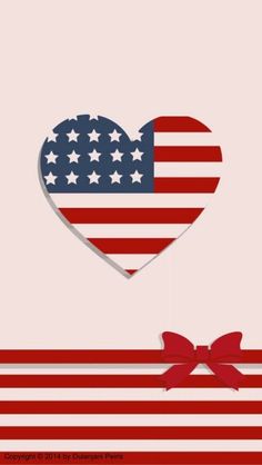 an american flag heart hanging on a string with a bow in front of the image