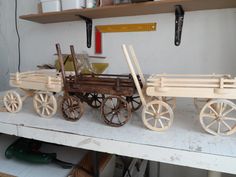 an old fashioned wooden wagon is sitting on a shelf