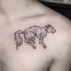 a black and white image of a horse on the back of a man's chest