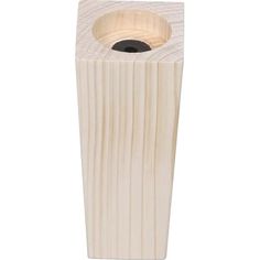 a wooden toothbrush holder with a black hole in the middle and white wood grain