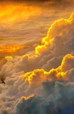 an airplane is flying high above the clouds at sunset or sunrise in this photo, it appears to be very colorful