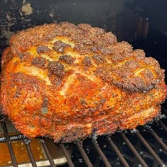 a large piece of meat cooking on top of a grill