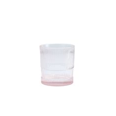 a clear glass cup sitting on top of a white table