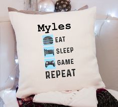 a pillow that says myles eat sleep game repeat