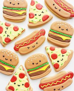 decorated cookies are arranged in the shape of hamburgers, hot dogs and pizza slices