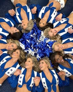 a group of cheerleaders standing in a circle