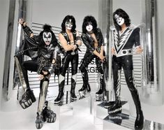 the kiss band posing for a photo in their black and white outfits