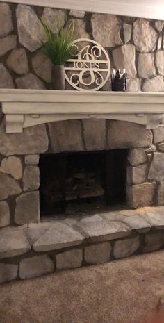 a stone fireplace with a sign that says joness on it and a potted plant