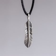 Carry the protection and blessings of the guardian angel feather necklace crafted in fine oxidized sterling silver ★Item Details *Material: Fine 925 Sterling Silver  *Measurements: 42x10mm approx. *Silver Chain length: 19.68" ✔ Made to Order. Each piece is hand-made with exceptional details and fine craftsmanship. Ready to Ship within 2-4 weeks. ✔ Free shipping within North America with tracking and insurance. Shipping to the rest of the world will be a $25 CAD flat fee. ✔ Each item will be sent Silver Necklace For Men, Silver Feather Necklace, Angel Feather, Oxidized Silver Necklace, Feather Necklace, Mens Necklace, Necklace Craft, Feather Pendant, Silver Feather