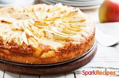 a pie with apples on top is sitting on a table