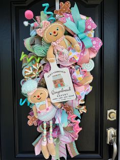 a wreath made to look like a baby's first christmas or new year's eve door hanger