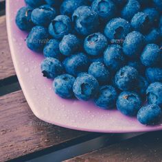 fresh blueberries in a pink bowl on a wooden table - stock photo - images