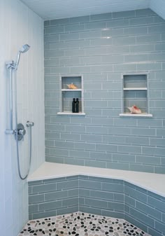 a tiled shower with two shelves above it