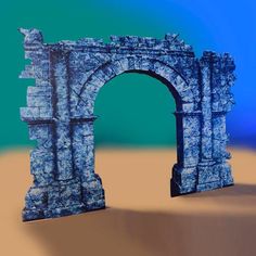 an arch in the sand on a blue and green background